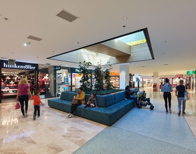 Mall EG - türkise Sitzmöbel in der Mitte des Ganges