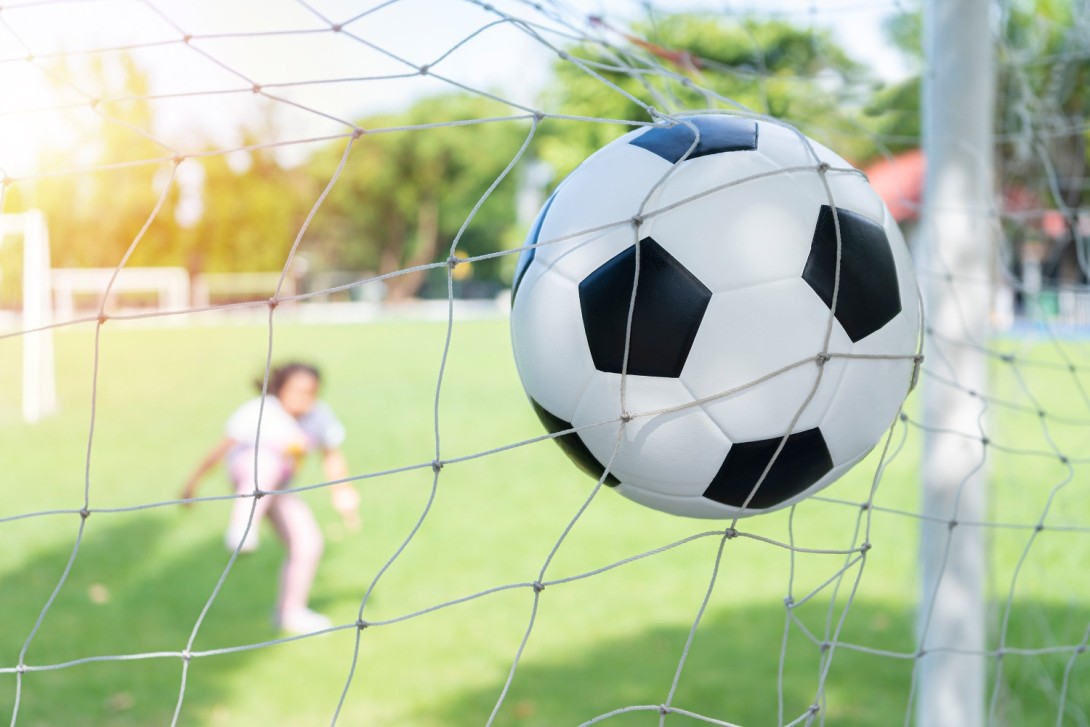 soccer ball goal with net girl kicks soccer ball soccer field v4